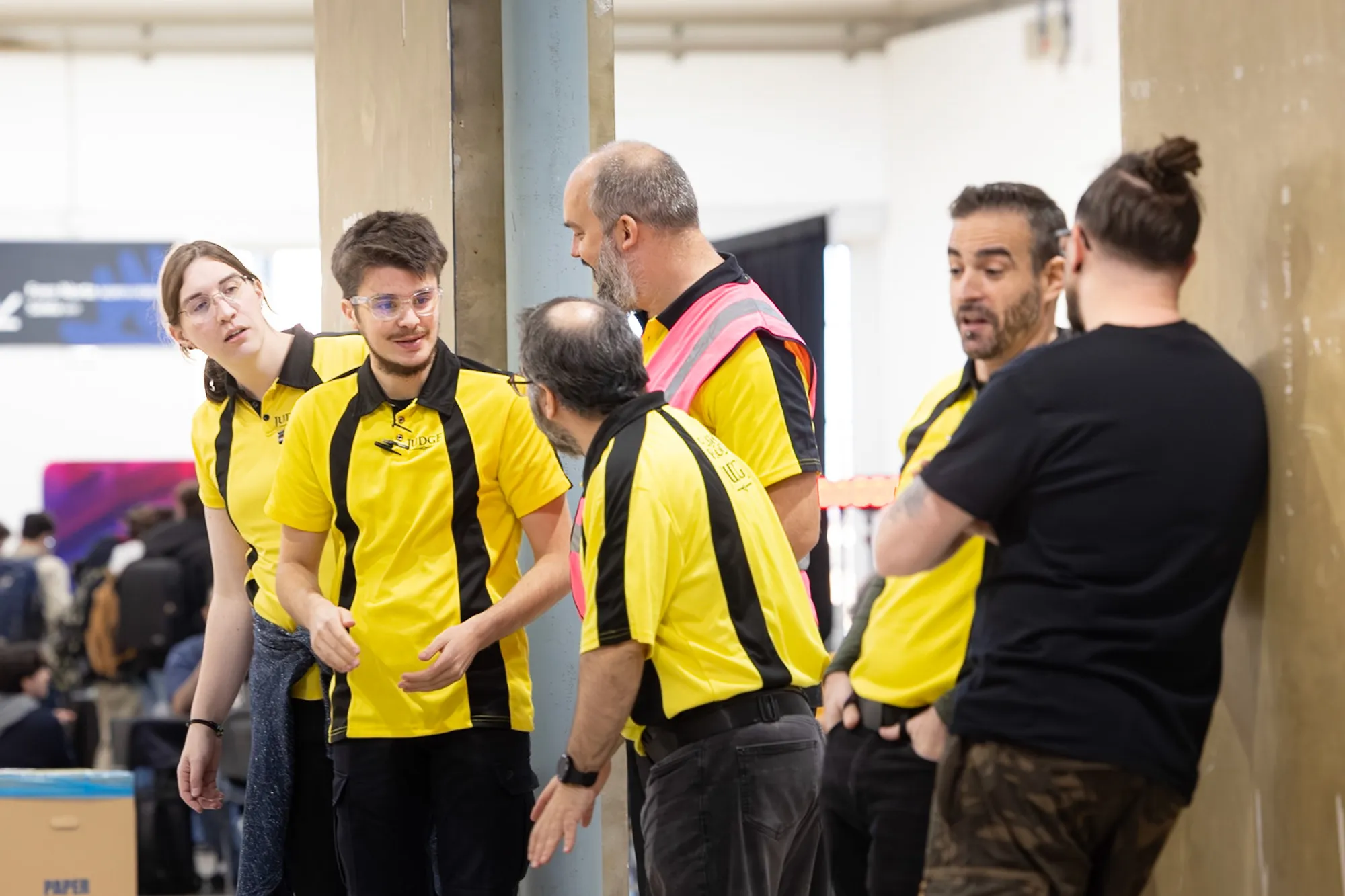 Several judges speaking with the Experience Coordinator